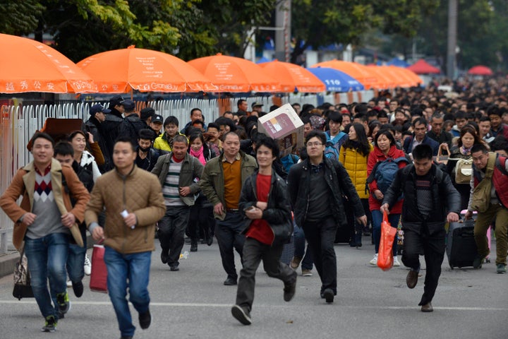 Passengers queue up to enter Guangzhou railway station in Guangzhou, Feb. 2, 2016.