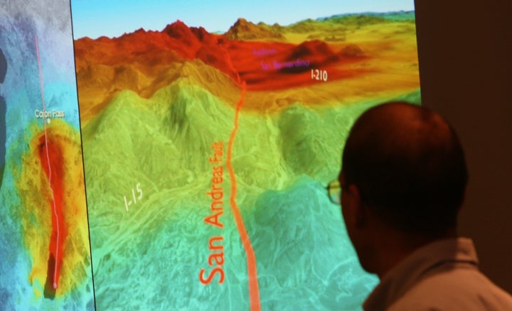 A research geophysicist with the United States Geological Survey looks at a series of images that illustrate the seismic wave