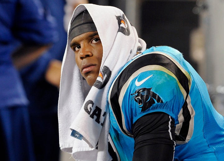 Carolina Panthers quarterback Cam Newton sits on the team's bench frustrated late in fourth quarter action against the New Yo