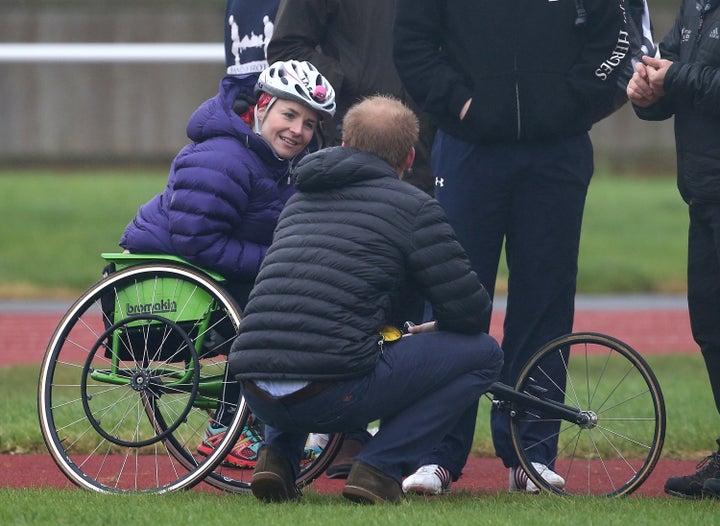 Prince Harry, talking to Pollock on the track