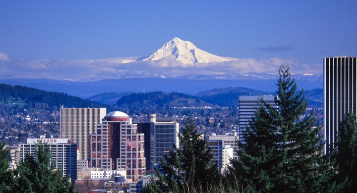 Snow-covered Mt. Hood looms over buildings in downtown Portland, Oregon.