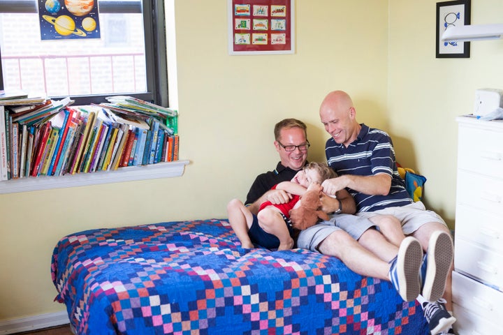 Dads Daniel and Andrew with their son Gabe in Queens, New York.