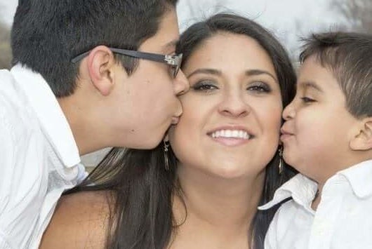 Lesly Sophia Cortez-Martinez poses for a photo with two of her children.