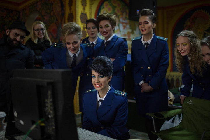 "Chaika" co-director and Pussy Riot frontwoman Nadya Tolokonnikova looks at footage from the music video with other band members. 