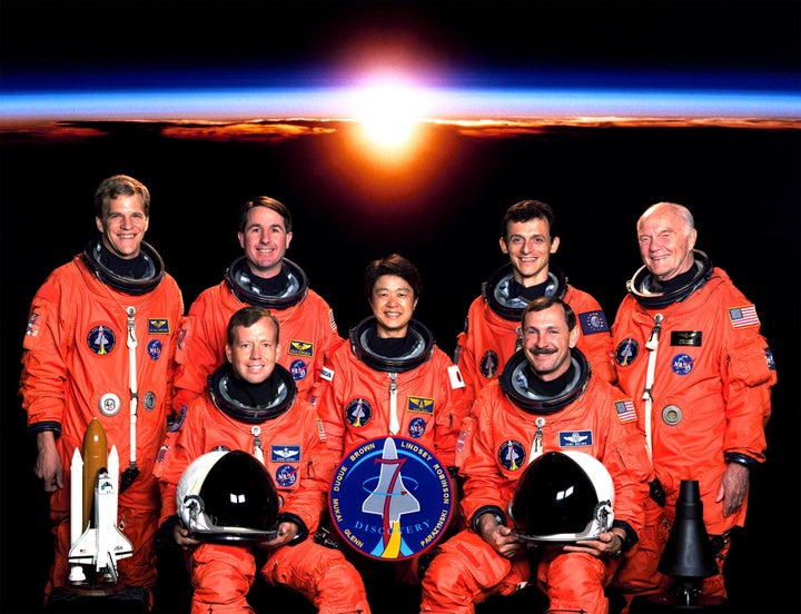 Sen. Glenn (far right), who is classified as a payload specialist, poses with the rest of the crew of his 1998 space shuttle