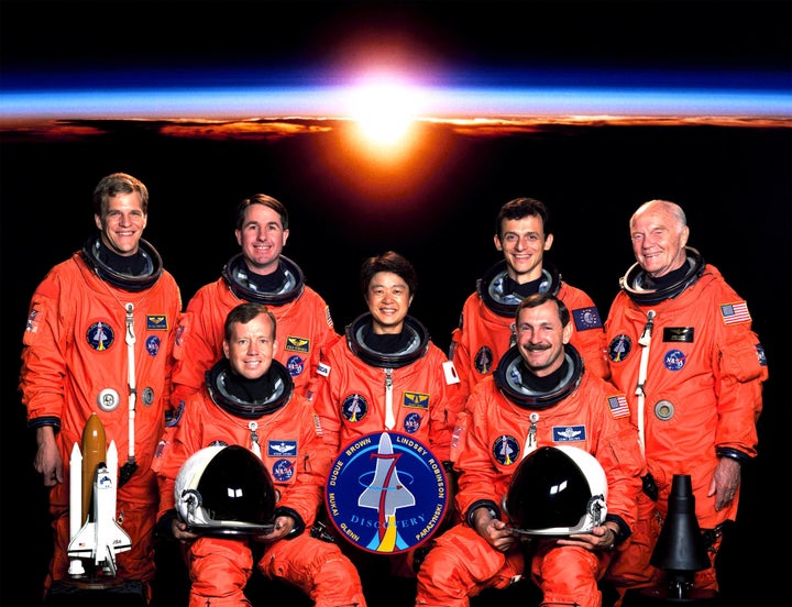 Sen. Glenn (far right), who is classified as a payload specialist, poses with the rest of the crew of his 1998 space shuttle flight. 