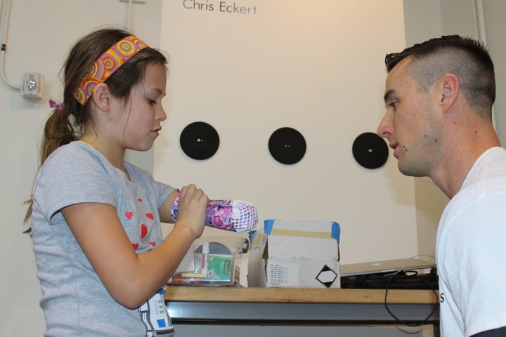 Sean Boatright, a professional prosthetis, discussing the fit of Jordan’s wearable prototype.