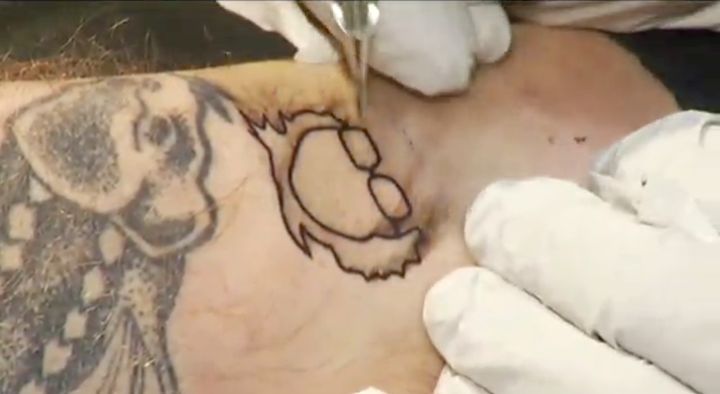 A man gets a free Bernie Sanders tattoo at a Vermont tattoo parlor.