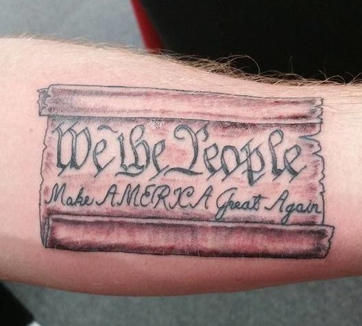 An image of the U.S. Constitution is see tattooed on someone's arm, along with Trump's campaign slogan.