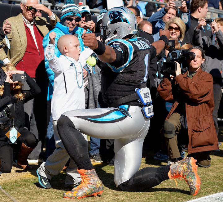 CHARLOTTE, NC - NOVEMBER 22: Cam Newton #1 of the Carolina Panthers greets a young fan before their game against the Washington Redskins at Bank of America Stadium on November 22, 2015 in Charlotte, North Carolina. 