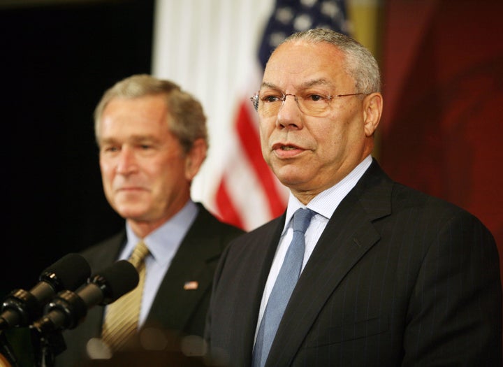 Former Secretary of State Colin Powell, right, introduces U.S. President George W. Bush at the Initative for Global Developme