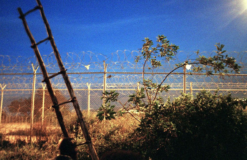 A ladder leans against the fence that separates Melilla and Morocco. 