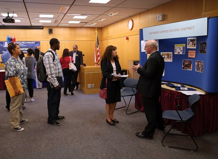 Job seekers line up to meet with a recruiter for the Hayward Unified School District in April 2013. 