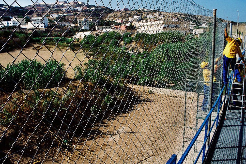 Workers heighten the fence to six meters in an attempt to keep migrants out of Melilla.