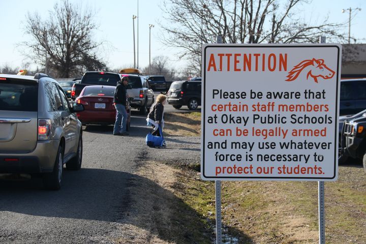 New signs posted on the grounds of Okay Public Schools in Oklahoma warn that staff members may be armed.