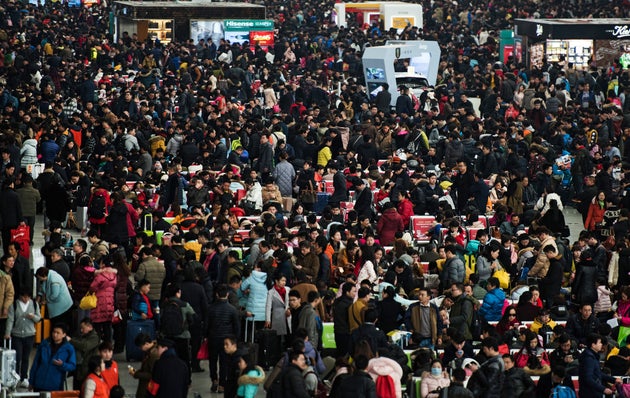 Passengers crowd the Shanghai Hongqiao railway station as they wait to board their trains to head to...
