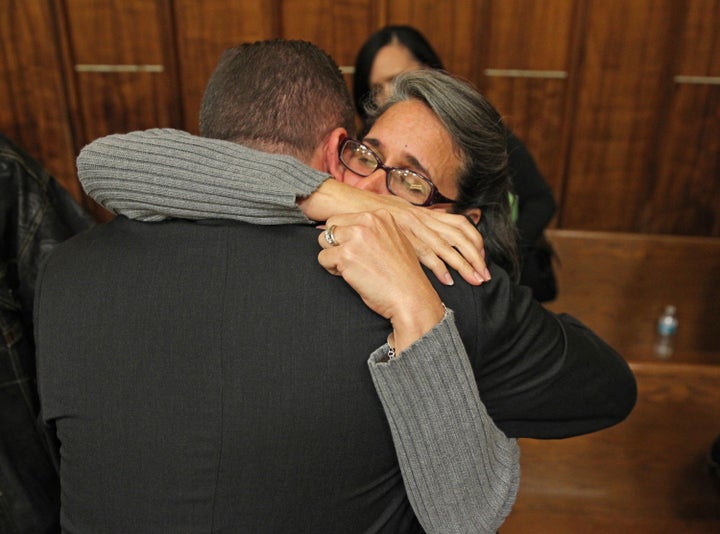 Carolyn Knox, mother of murder victim Jennifer Alfonso, receives a hug from Miami-Dade homocide Det. Jonathan Grossman after