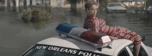 Beyoncé sits on top of a New Orleans police car in her new video, "Formation."