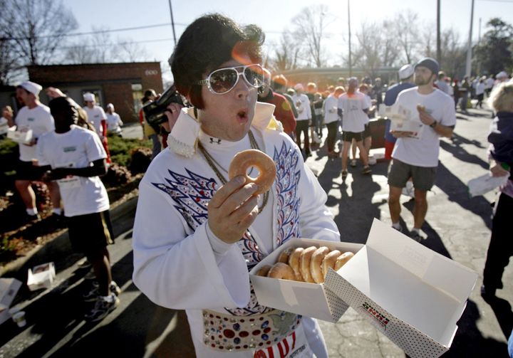 A runner dressed as Elvis chows down on his box of a dozen glazed donuts at the race's halfway point in Raleigh, North Carolina, back in 2007.