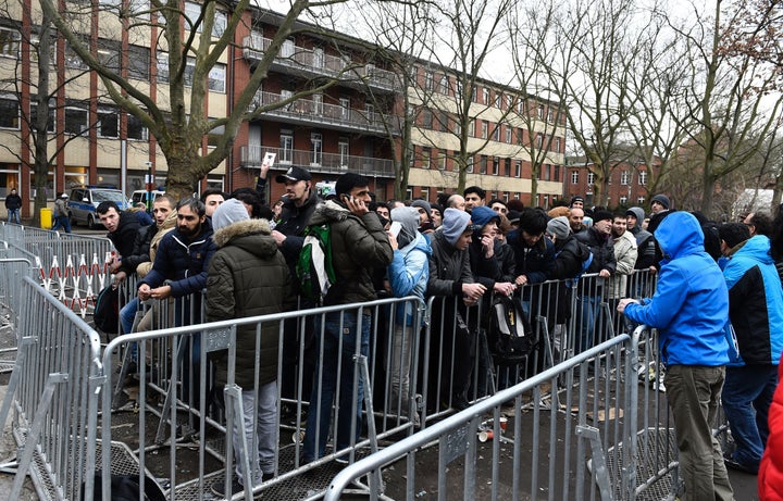 Some 1.1 million people entered Germany last year. Migrants and refugees line up outside the Office of Health and Social Affairs in Berlin.