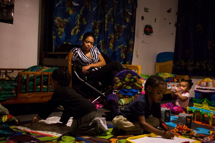 Brittny Giles, of Flint, Michigan, watches her sons practice drawing their letters at their home on Feb. 4, 2016. She now questions whether or not she wants to continue living in the city. "I want to stay in Flint, because I was born and raised in Flint, but if I have to move to better my family, I will," Giles said.