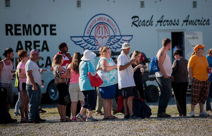 People stand in line for treatment at a Remote Area Medical clinic at the Wise County Fairgrounds in Wise, Virginia, on July 17, 2015. These pop-up clinics provide free care to people who can't afford services.
