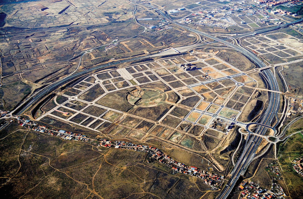 The nearly-empty El Cañaveral development near Madrid, seen from above in 2014. The strip of housing in the foreground is La Cañada Real Galiana, said to be Europe's largest shantytown. Several years ago, Madrid demolished parts of the informal settlement. 