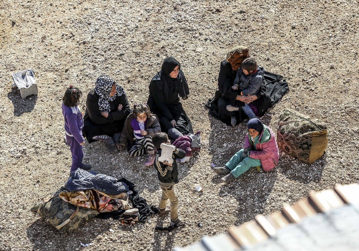 Syrians rest at the Turkish-Syrian border near Aleppo. International powers are due to meet on Thursday to revive the talks,