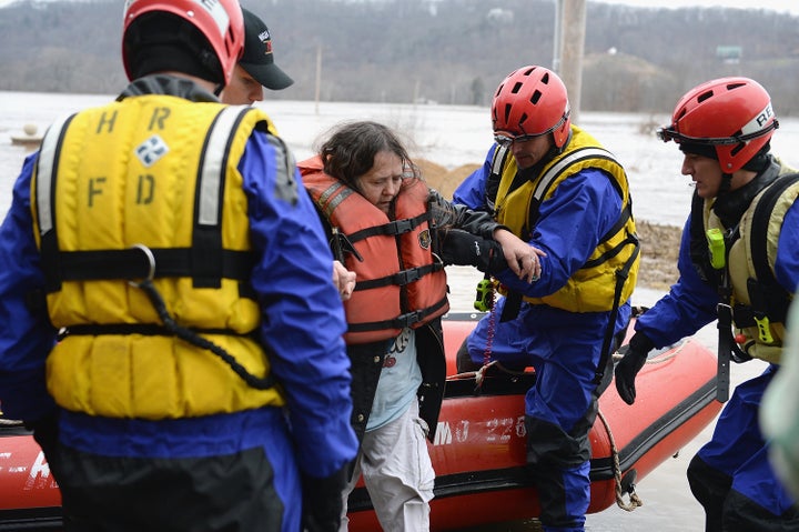 The High Ridge Fire Department performs a water rescue to evacuate stranded residents along the Meremac River on Dec. 30, 2015, in Eureka, Missouri.