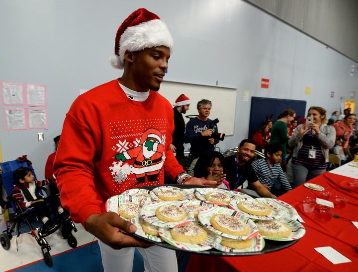 Newton carries a tray of cookies to hand out to Metro School students on Tuesday, Dec. 15, 2015, in Charlotte, North Carolina