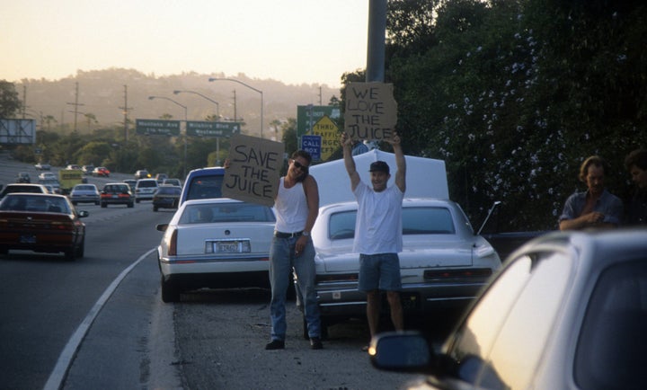 Motorists wave pro-Simpson signs along the 405 freeway.