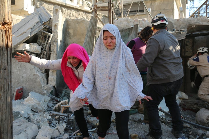 Syrian children react following a reported air strike in Aleppo. The rebel-held city has been at the center of a fierce advan