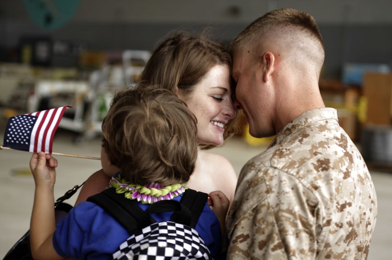 Savannah Dejong holding her son Rhone (3) greets her husband, Daniel with 1/3 Marines Bravo Company, upon his return to Hawaii on June 13, 2010, following a seven-month deployment in southern Afghanistan.
