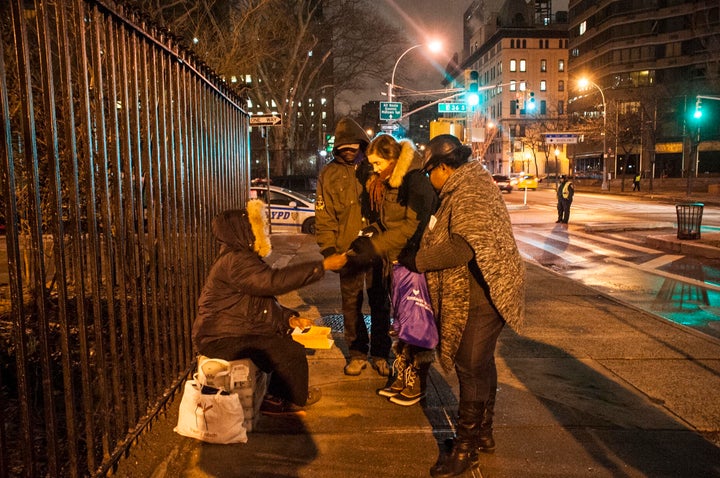 West Point student Emma Spell takes a card from a "decoy" homeless person near the end of her team's canvass for the annual HOPE count.