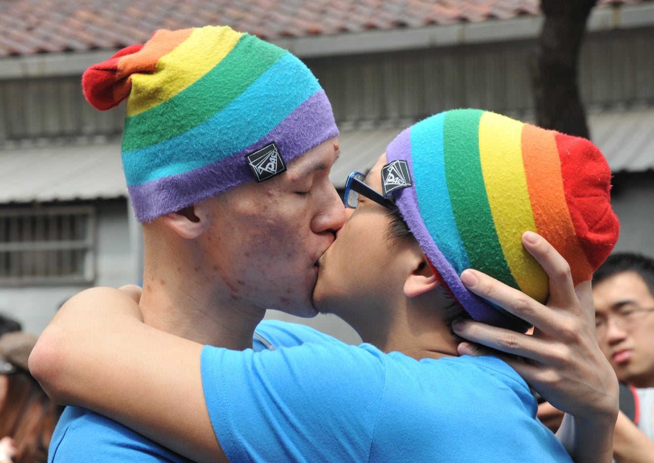 A same-sex couples kiss during an event outside the Legislative Council in Taipei on March 16, 2014. Dozens of members of the gay community gathered to demand same-sex marriages.