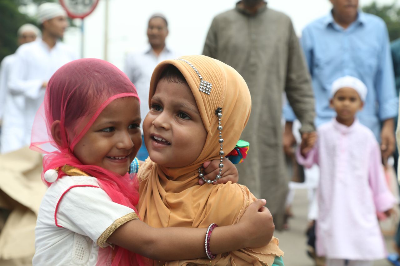 Children and men embracing each other after offering prayer during the 'Eid' Festival on July 18, 2015 in kolkata, India.