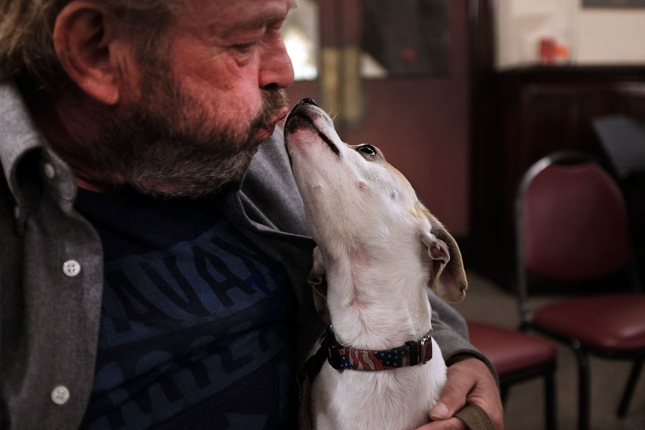 Craig, who is homeless, sits with his dog, Chester, at Broad Street Ministry on September 22, 2015 in Philadelphia, Pennsylvania.