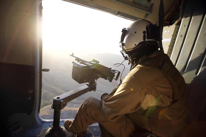 An Afghan soldier is seen in a helicopter during a military operation from Sar-e Pol, Afghanistan, on Aug. 29, 2015, as part of the operations which have been launched against the Islamic State in Afghanistan.