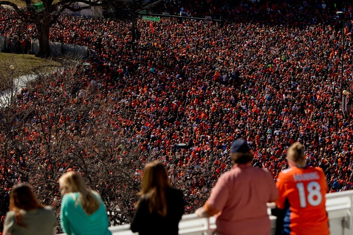 Fans of the Denver Broncos fill Civic Center Park as more watch from a balcony during a victory rally to celebrate their Supe