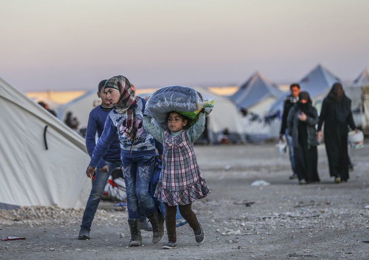 People take shelter near the Bab al Salameh border crossing on the Turkish-Syrian border north of Aleppo, Syria. The Syrian regime's offensive on Aleppo has prompted a new wave of displacement that could spill over into Europe.