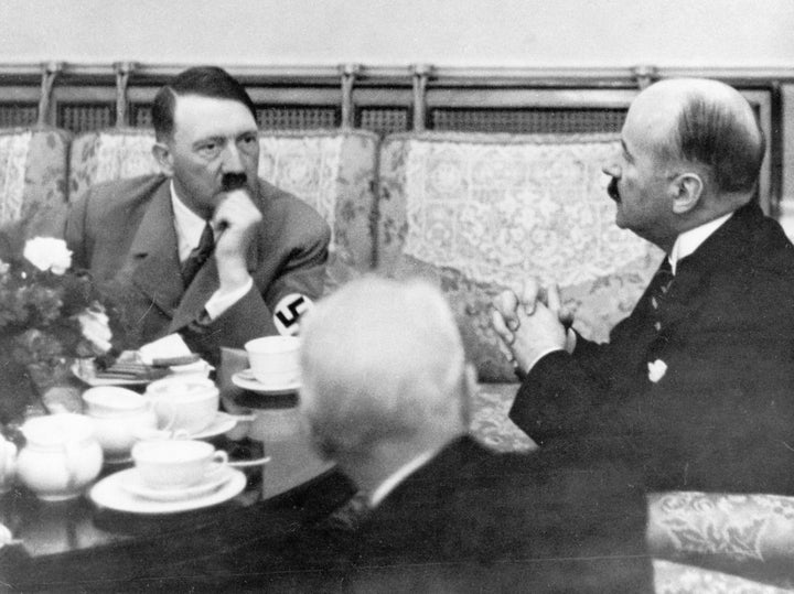 Hitler drinks tea at a hotel in Germany while meeting with the French Ambassador Andre Francois-Poncet in 1937.