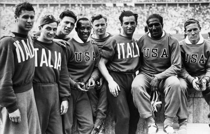 Ralph Metcalfe (second to the right) and the rest of the 4x100 USA team, pictured with the silver medal-winning 4x100 Italian team.