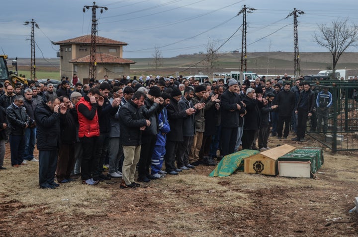 Mourners at a funeral for civilians killed in a Kurd-linked bomb attack targeting a police station in Diyarbakir.