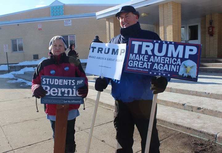 Jim Bennett and Sandy Paradis stand in front of a polling location in Manchester, New Hampshire, on Tuesday.