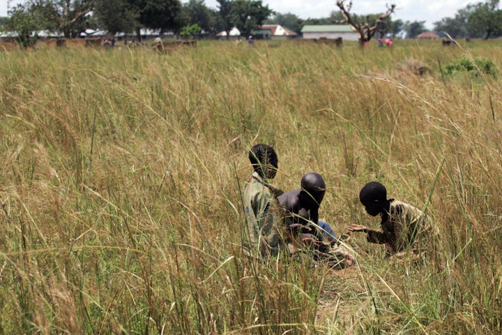 Boys search for food at a camp for internally displaced people in north Uganda, the East African country where Whitaker was shooting "The Last King of Scotland," when he encountered a school for former child soldiers and orphans.