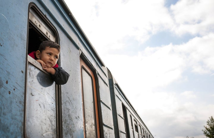 A boy looks out the train window on the migrant trail to Europe, where thousands have fled violence in countries such as Syri