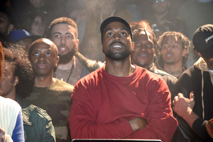 Yeezy and his crew looking outward towards the stage.