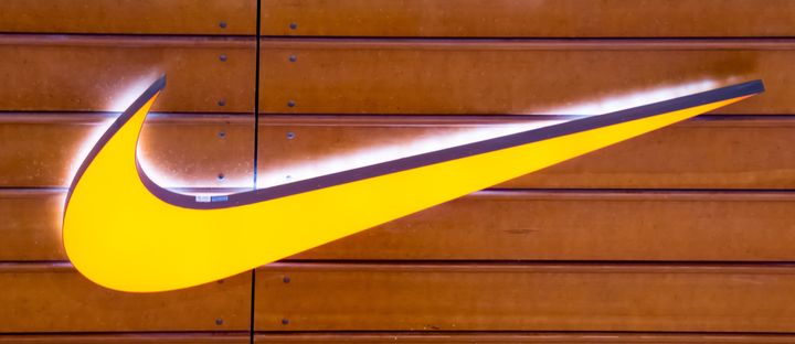 The Nike "swoosh" is seen on a brown wooden wall in this 2015 file photo. The company won't manufacture custom shoes with the words "Muslim" or "Islam" on them.