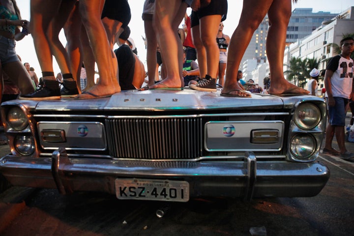 Revelers stand and dance atop a party vehicle during Carnival celebrations at the Banda de Ipanema 'bloco,' or street parade, on February 9, 2016 in Rio de Janeiro, Brazil. Festivities have continued throughout major Brazilian cities for Carnival in spite of the threat of the Zika virus.