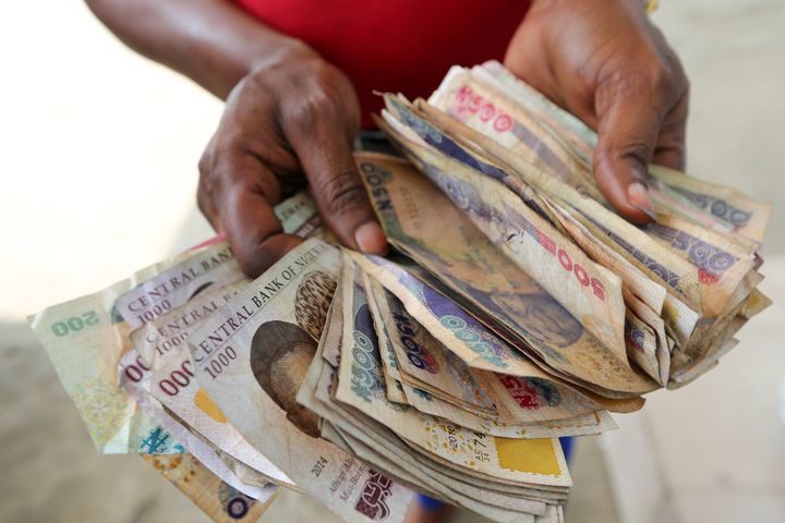 A large bundle of naira banknotes. The currency has plummeted in value on the black market amid the economic crisis.